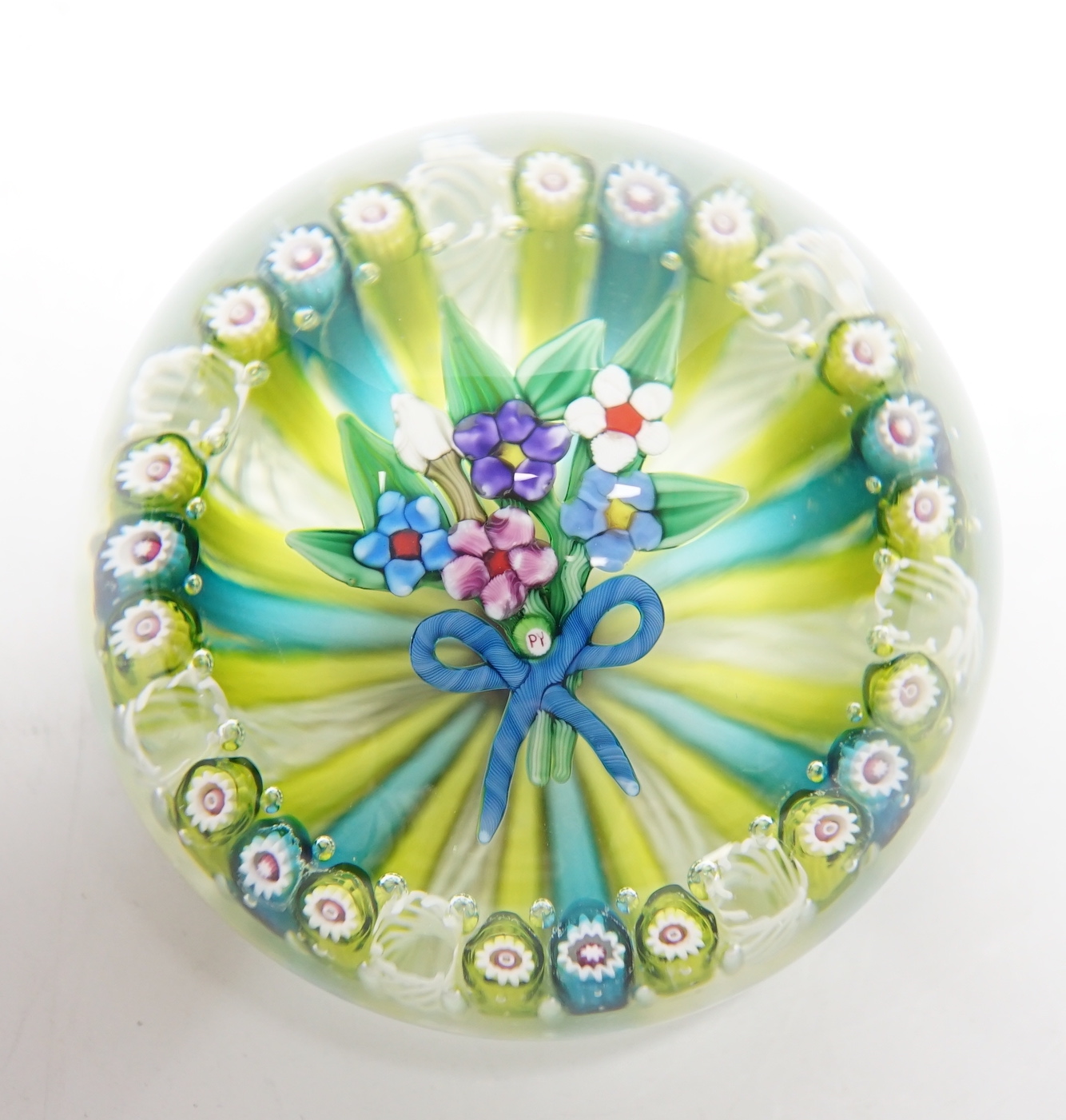 A Paul Ysart ‘small flower bouquet’ glass paperweight, Caithness or Harland period, ‘PY’ cane, multi coloured latticino and cane ground, fire polished pontil, 7cm